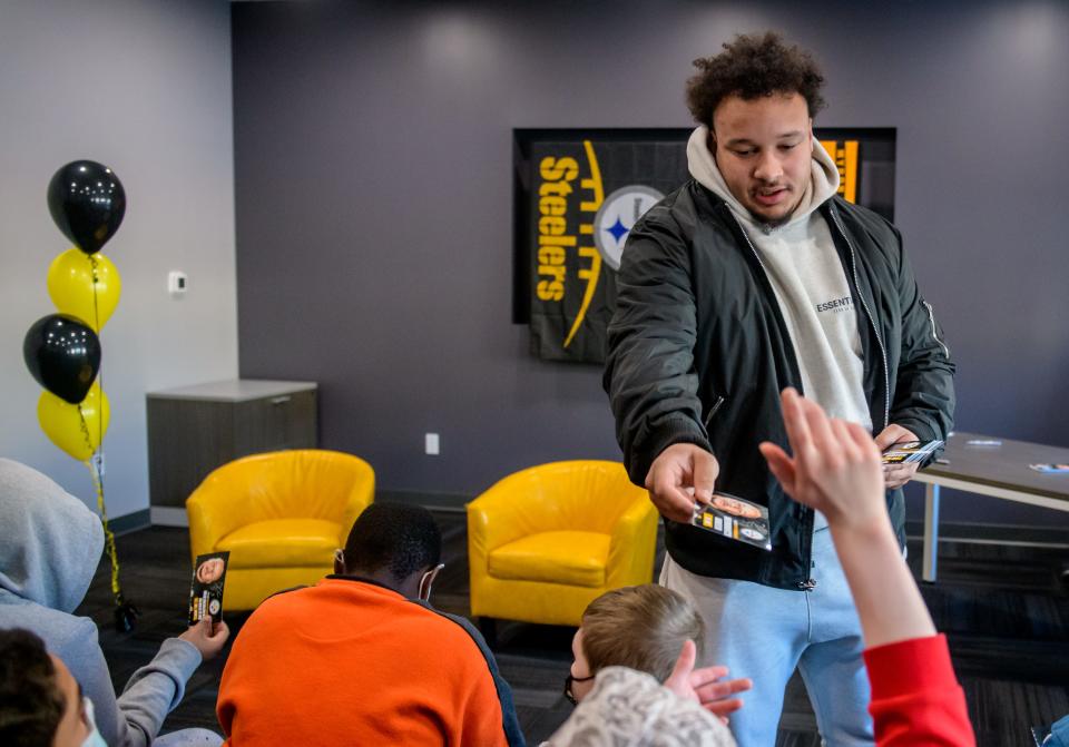Pittsburgh Steelers rookie center and Peoria High grad Kendrick Green hands out autographed photos Wednesday, Jan. 26. 2022 to kids at the Children's Home Association's Kiefer School on NE Madison in Peoria. Green answered questions and posed for photos during the event.