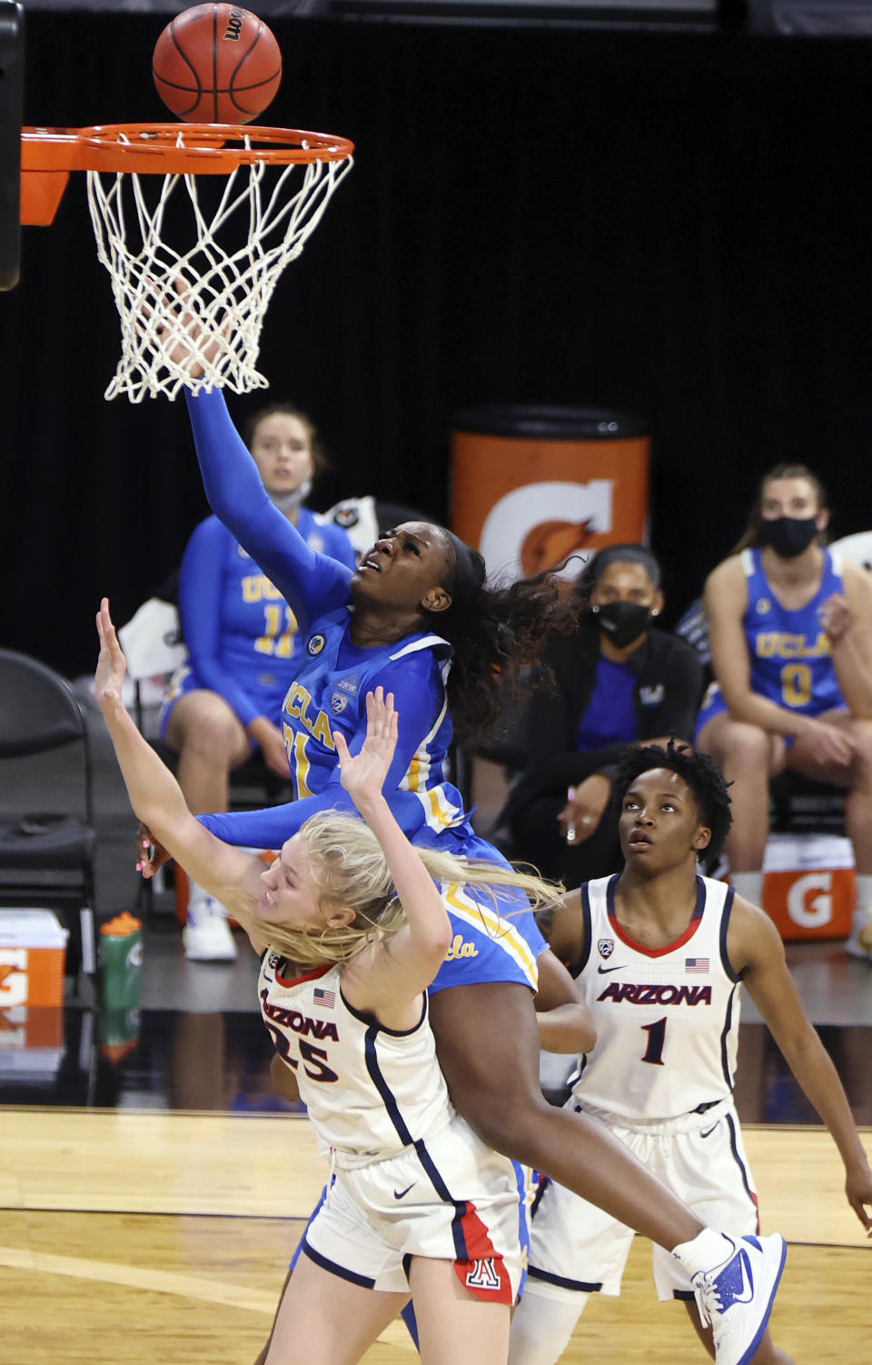 UCLA forward Michaela Onyenwere (21) shoots over Arizona forward Cate Reese (25) during the second half of an NCAA college basketball game in the semifinals of the Pac-12 women's tournament Friday, March 5, 2021, in Las Vegas. (AP Photo/Isaac Brekken)