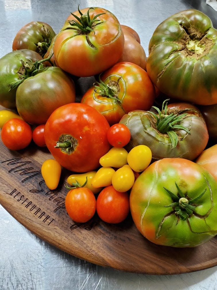 Red tomatoes and pear-shaped yellow tomatoes grow in the garden at MM Shapley's Restaurant in Ridgeland.