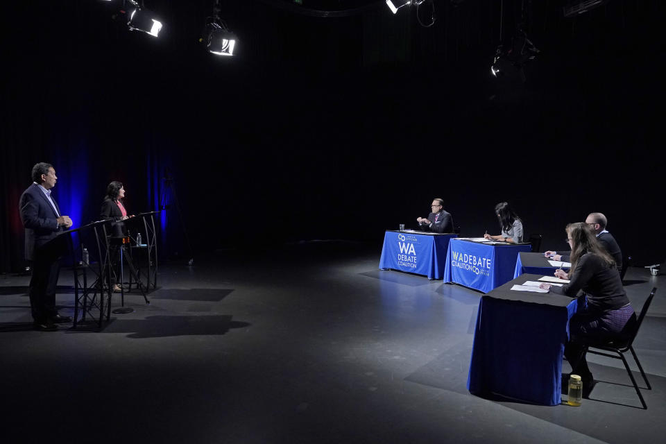 Bruce Harrell, left, and Lorena Gonzalez, second from left, take part Thursday, Oct. 14, 2021, in the first of two debates in Seattle scheduled before the November election for the office of mayor. (AP Photo/Ted S. Warren, Pool)