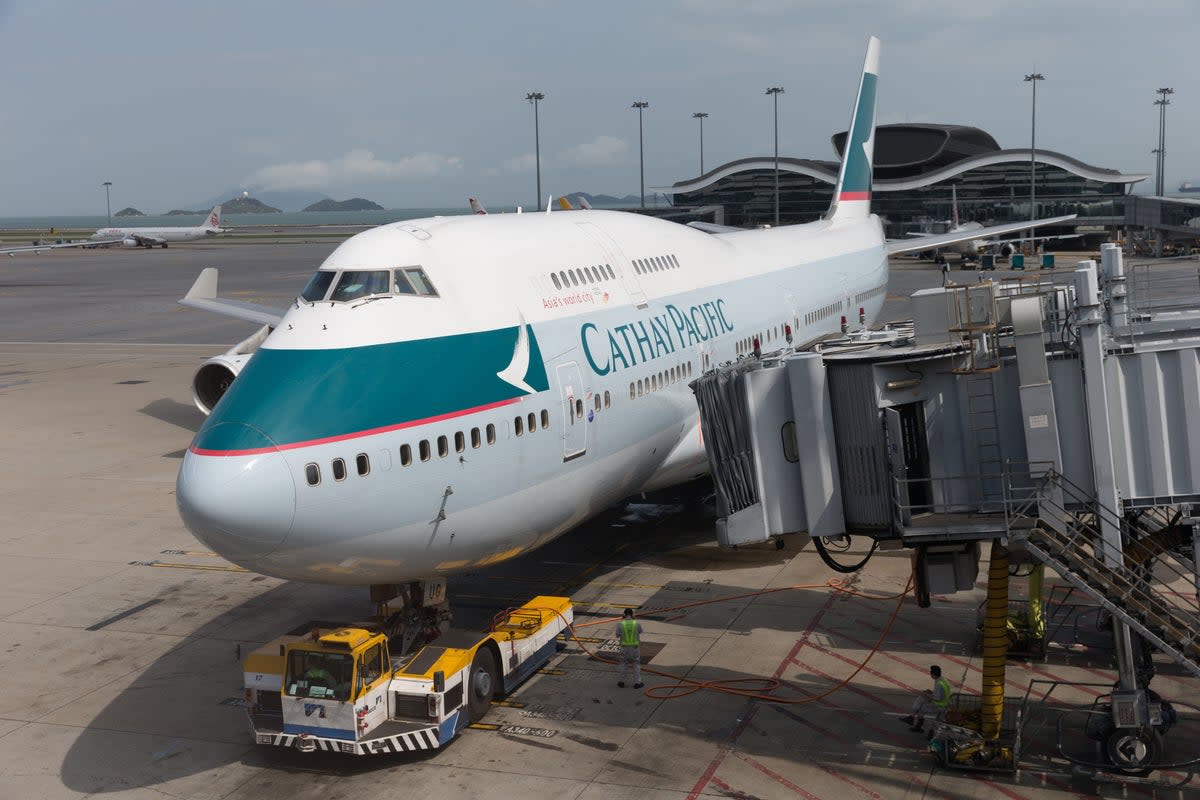 A Cathay Pacific Airways plane at Hong Kong International Airport (stock image). A flight attendant was forced to hold a bathroom door during a 16-hour flight from Hong Kong to New York City this week  (Getty Images)