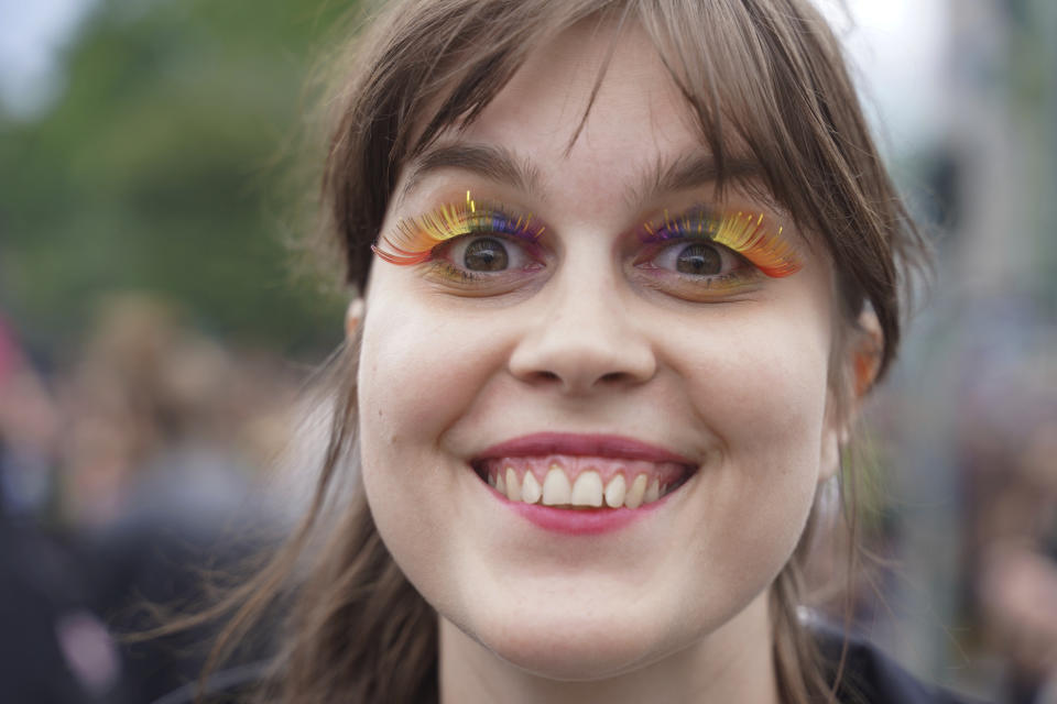 A woman takes part in the "Rave the Planet" parade in Berlin, Saturday, July 9, 2022. A techno parade whose initiators include the founder of Berlin's once-popular Love Parade has started in the streets of the German capital with calls for the city’s electronic music culture to be added to a world heritage list. The “Rave the Planet” parade set out on Saturday in cool, rainy weather. (Joerg Carstensen/dpa via AP)