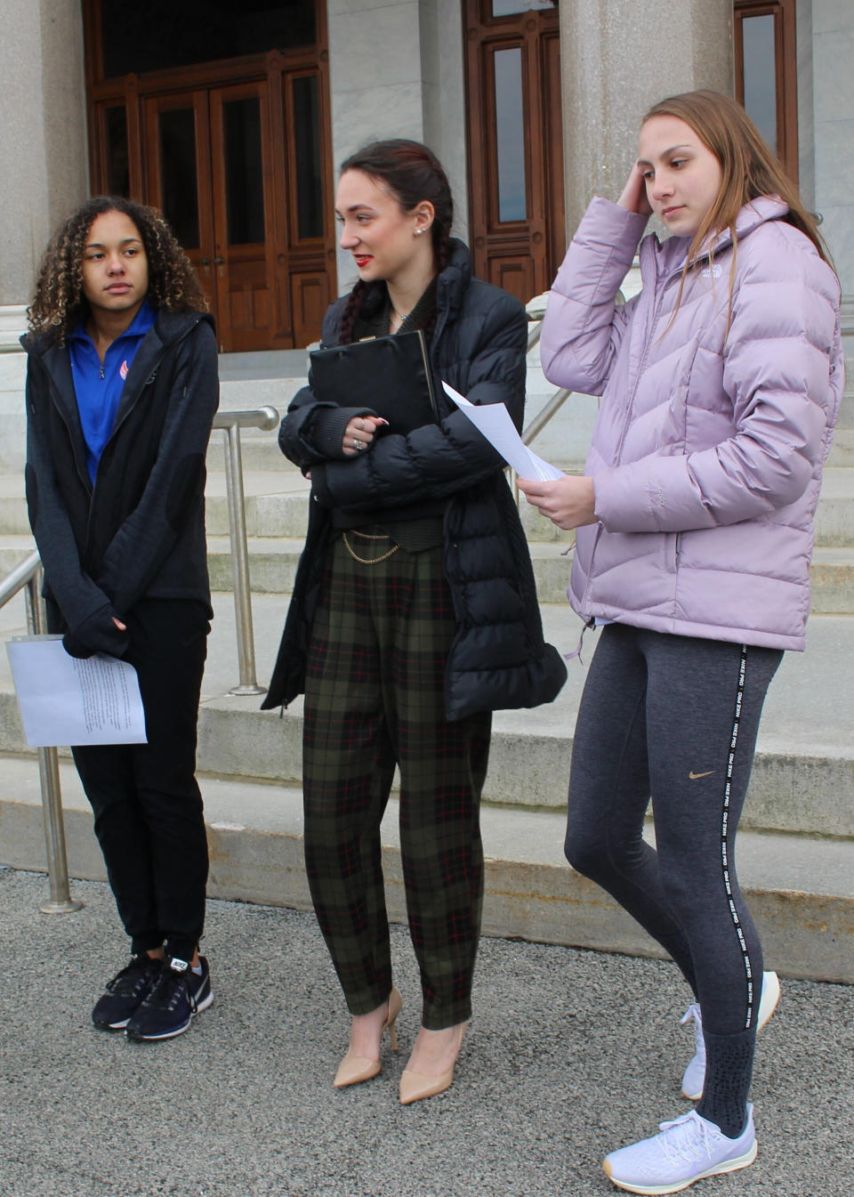 FILE - In this Feb. 12, 2020 file photo, high school track athletes Alanna Smith, left, Selina Soule, center, and Chelsea Mitchell prepare to speak at a news conference outside the Connecticut State Capitol in Hartford, Conn. The U.S. Department of Education is threatening to withhold some federal funding for Connecticut school districts if they follow a state policy that allows transgender girls to compete as girls in high school sports. In response to a complaint filed last year by several cisgender female track athletes who argued that two transgender female runners had an unfair physical advantage, the federal agency's office for civil rights determined in May that Connecticut's policy violates the civil rights of athletes who are not transgender. (AP Photo/Pat Eaton-Robb, File)