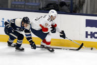 Florida Panthers forward Alex Wennberg, right, of Sweden, controls the puck in front of Columbus Blue Jackets forward Cam Atkinson during the first period of an NHL hockey game in Columbus, Ohio, Tuesday, Jan. 26, 2021. (AP Photo/Paul Vernon)