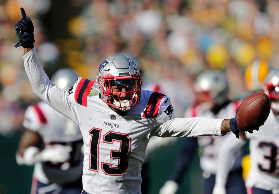 Patriots defensive back Jack Jones (13) celebrates after recovering a fumble by Packers wide receiver Romeo Doubs during Sunday's game in  Green Bay.