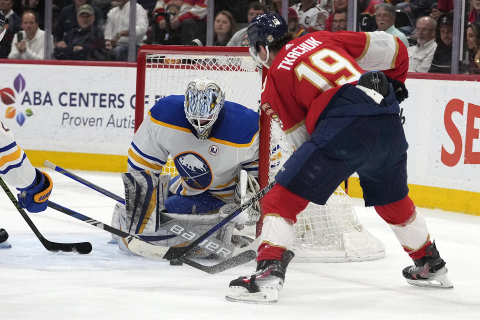 Buffalo Sabres goaltender Ukko-Pekka Luukkonen, left, defends the goal against Florida Panthers left wing Matthew Tkachuk (19) during the first period of an NHL hockey game, Saturday, April 13, 2024, in Sunrise, Fla. (AP Photo/Lynne Sladky)