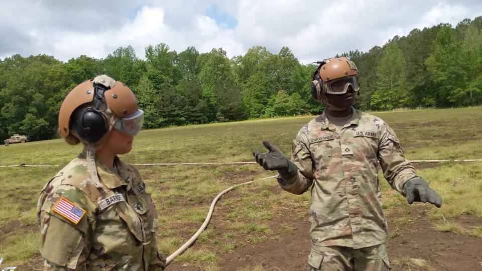 Private First Class Christian Lankoande, right, and Specialist Amanda barboe, left, explain how they refuel helicopters during a training at Fort Campbell military installation.