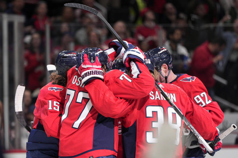 Washington Capitals left wing Sonny Milano (15) celebrates his goal against the Columbus Blue Jackets with teammates, including right wing T.J. Oshie (77), right wing Anthony Mantha (39) and center Evgeny Kuznetsov (92), during the first period of an NHL hockey game Saturday, Nov. 4, 2023, in Washington. (AP Photo/Jess Rapfogel)