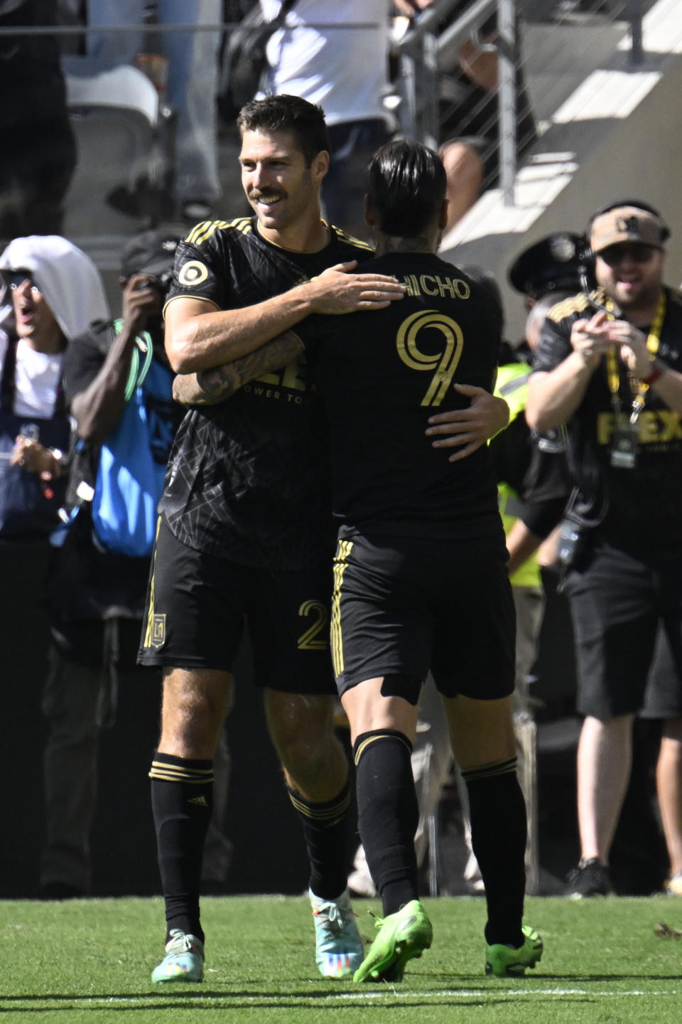 Los Angeles FC midfielder Ryan Hollingshead (24) congratulates Cristian Arango (9) for his goal against Austin FC during the first half of an MLS playoff Western Conference final soccer match Sunday, Oct. 30, 2022, in Los Angeles. (AP Photo/John McCoy)