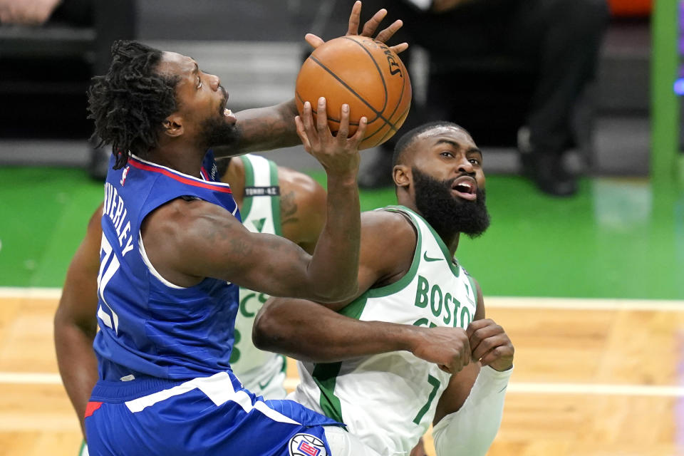 LA Clippers guard Patrick Beverley (21) drives to the hoop against Boston Celtics guard Jaylen Brown (7) in the first quarter of an NBA basketball game, Tuesday, March 2, 2021, in Boston. (AP Photo/Elise Amendola)