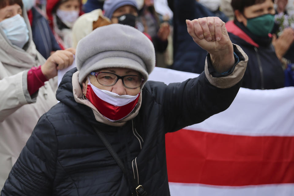 An elderly woman gestures during an opposition rally to protest the official presidential election results in Minsk, Belarus, Monday, Oct. 12, 2020. Riot police clashed with protesting pensioners in central Minsk on Monday. The pensioners marched in a column through central Minsk, carrying flowers and posters with slogans such as "The grandmas are with you (protesters)." (AP Photo)