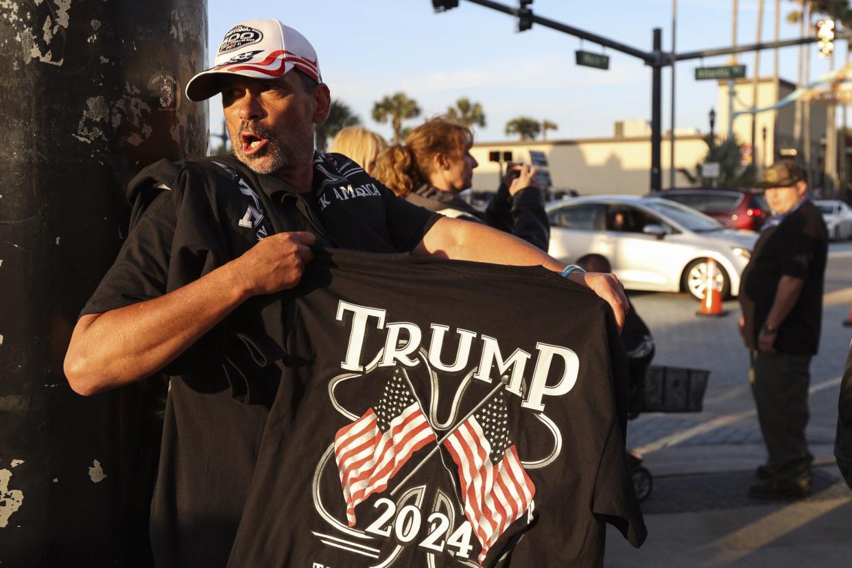 A man sells Trump shirts along Main Street in Daytona, FL during the start of Bike Week on Friday, March 5, 2021. (Sam Thomas/Orlando Sentinel)