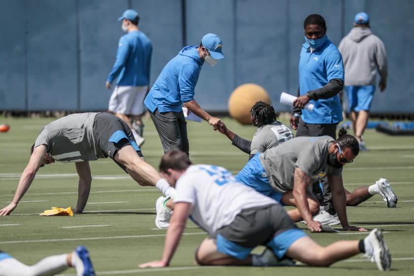 Costa Mesa, CA, Friday, May 14, 2021 - Head coach Brandon Staley greets linebacker Amen Ogbongbemiga as rookies work out at LA Chargers mini-camp at Hoag Performance Center. (Robert Gauthier/Los Angeles Times)