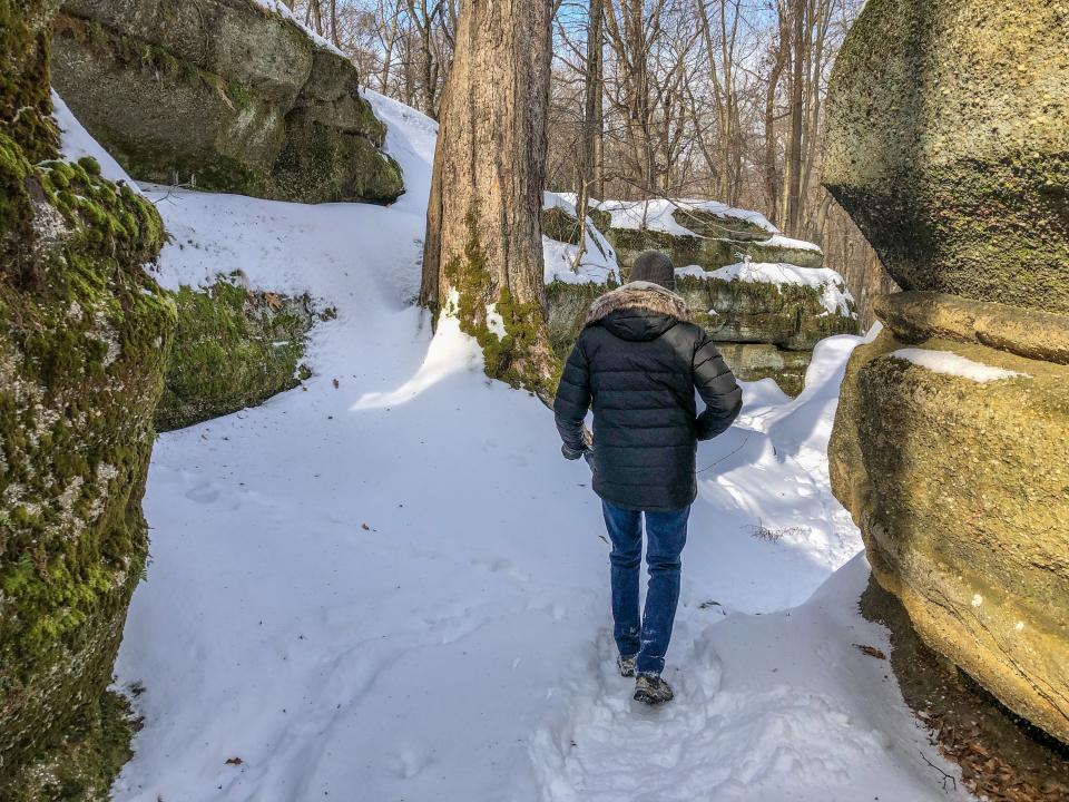 A hiker explores the beautiful formations at Nelson Kennedy Ledges State Park.