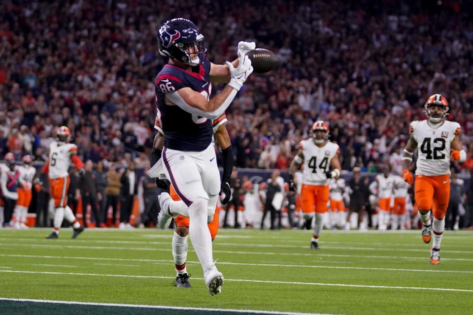 Houston Texans tight end Dalton Schultz catch a touchdown pass against the Cleveland Browns during the first half of a wild-card playoff game Saturday in Houston.