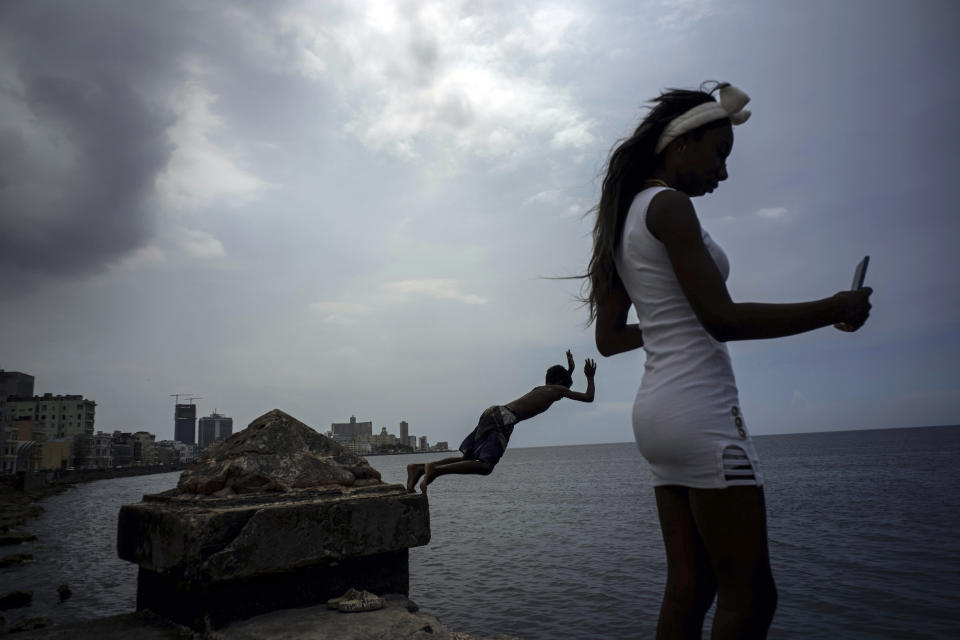 A youth dives off the malecon seawall into the water to cool off in Havana, Cuba, Wednesday, July 5, 2023. The entire planet sweltered for the two unofficial hottest days in human record keeping Monday and Tuesday, according to University of Maine scientists at the Climate Reanalyzer project. (AP Photo/Ramon Espinosa)