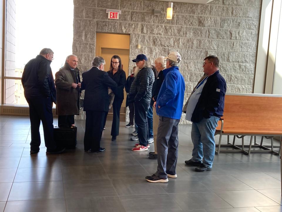 Somerset attorneys Arthur Frank and Joseph Macy speak to a handful of town residents who attended the hearing to dismiss the case against Brayton Point LLC on Tuesday.