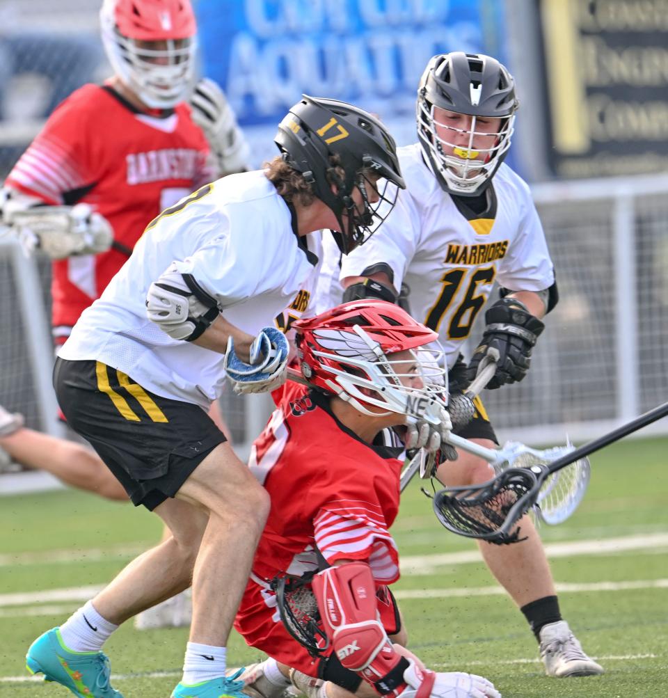 NORTH EASTHAM  5/16/23   Doug Carr of  Barnstable goes down under pressure from Peyton Kender (17) and Jackson Dalmau of Nauset.