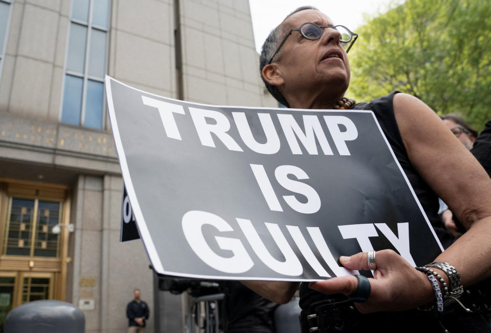 A demonstrator outside the Manhattan Federal Court following the verdict in the E. Jean Carroll rape case against Donald Trump, May 9