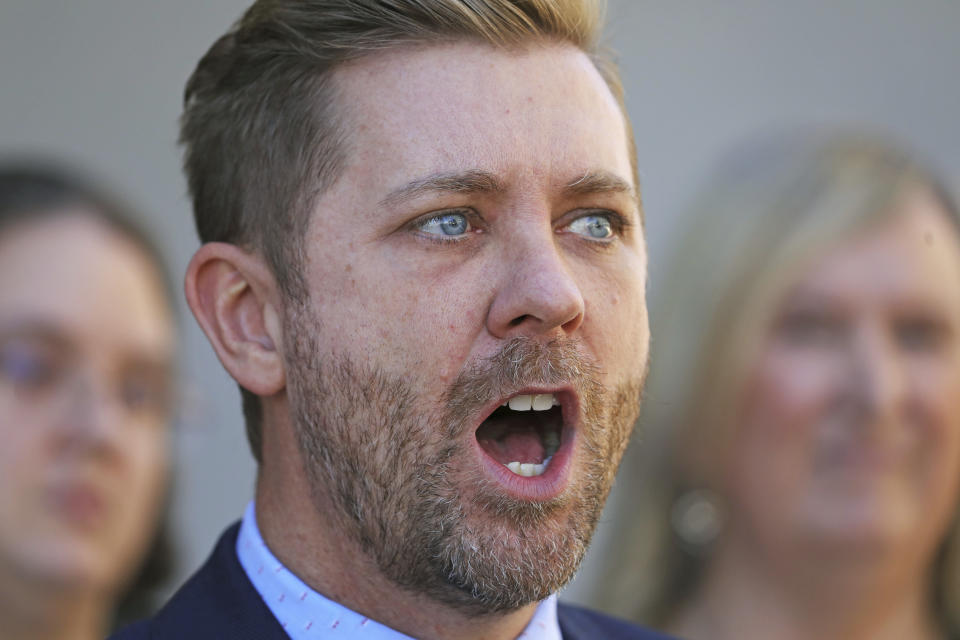 FILE - In this Sept. 26, 2019, file photo, Troy Williams, with Equality Utah, speaks during a news conference, in Salt Lake City. The Church of Jesus of Christ of Latter-day Saints is opposing a proposed ban on conversion therapy in Utah, just months after it said it wouldn't stand in the way of a similar rule under consideration. The church said in a statement posted Tuesday, Oct. 15, 2019, night that the regulatory rule prohibiting Utah psychologists from engaging in LBGTQ conversion therapy with minors would fail to safeguard "religious beliefs" and doesn't account for "important realities of gender identity in the development of children." (AP Photo/Rick Bowmer, File)