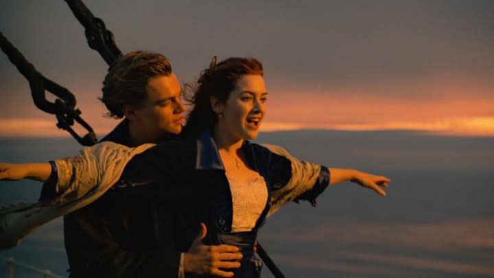 Leonardo DiCaprio and Kate Winslet as Jack and Rose posing on the ship's bow in Titanic.