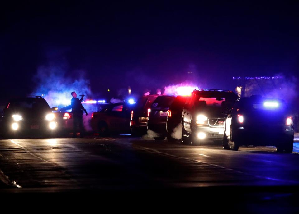 Police vehicles line Noe Road in Harrison on Jan. 9 after Robert Schmidt shot his wife, Sara Schmidt, and then killed himself.