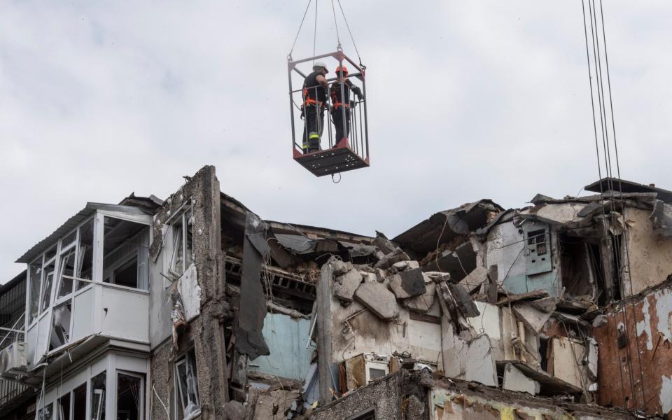 Firefighters search and clear an apartment block destroyed in a Russian missile attack in Mykolaiv on 29 June, 2022. - Julian Simmonds for The Telegraph/Julian Simmonds for The Telegraph
