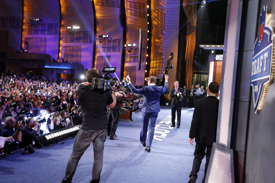 Johnny Manziel, from Texas A&M, celebrates as he walks onstage after being selected 22nd overall by the Cleveland Browns during the first round of the NFL football draft, Thursday, May 8, 2014, at Radio City Music Hall in New York. (AP Photo/Jason DeCrow)