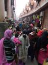 View of the narrow alley outside the market, where women sell vegetables, fruit and dried fish and shrimp.