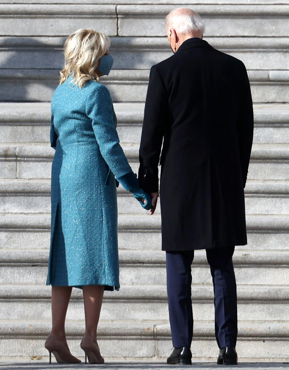 <p>President Biden and his wife Dr. Jill Biden hold hands as they arrive for the inauguration on the East Front of the U.S. Capitol. </p>