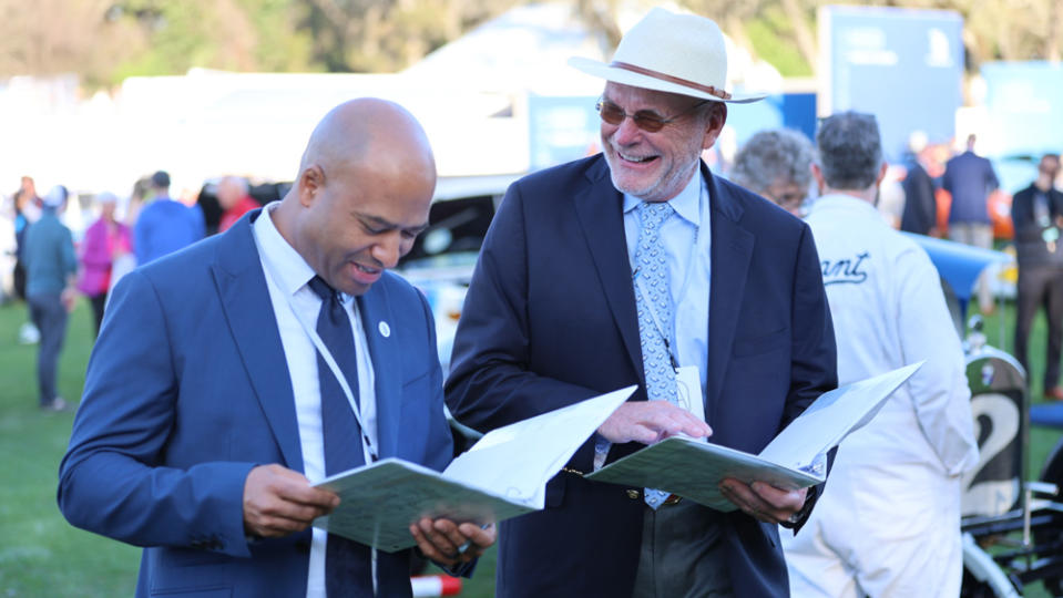 Two judges evaluating cars at the 2023 Amelia Island Concours d'Elegance.