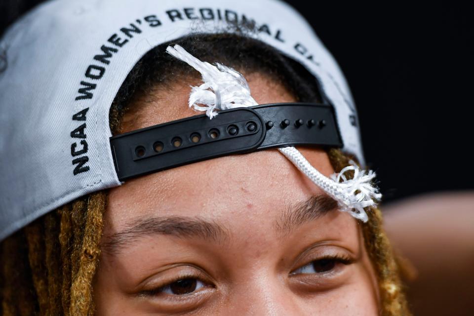Louisiana State University forward LaDazhia Williams (0) holds a piece of the net in her hat after winning the NCAA Women's Greenville Regional Elite Eight Basketball Tournament at Bon Secours Wellness Arena in Greenville, S.C. Sunday, March 26, 2023.   