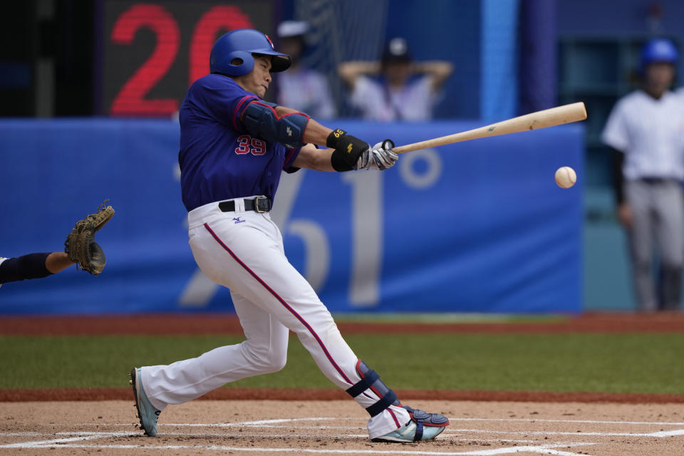 Taiwan's Wu Nien-Ting hits the ball during a stage group round B Baseball Men game against Hong Kong for the 19th Asian Games in Hangzhou, China on Tuesday, Oct. 3, 2023. At the Asian Games China has been going out of its way to be welcoming to the Taiwanese athletes, as it pursues a two-pronged strategy with the goal of taking over the island, which involves both wooing its people while threatening it militarily. (AP Photo/Ng Han Guan)