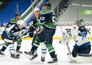 Vancouver Canucks center Bo Horvat (53) tries to screen in front of Winnipeg Jets goaltender Connor Hellebuyck (37) during the second period of an NHL hockey game Sunday, Feb. 21, 2021, in Vancouver, British Columbia. (Jonathan Hayward/The Canadian Press via AP)