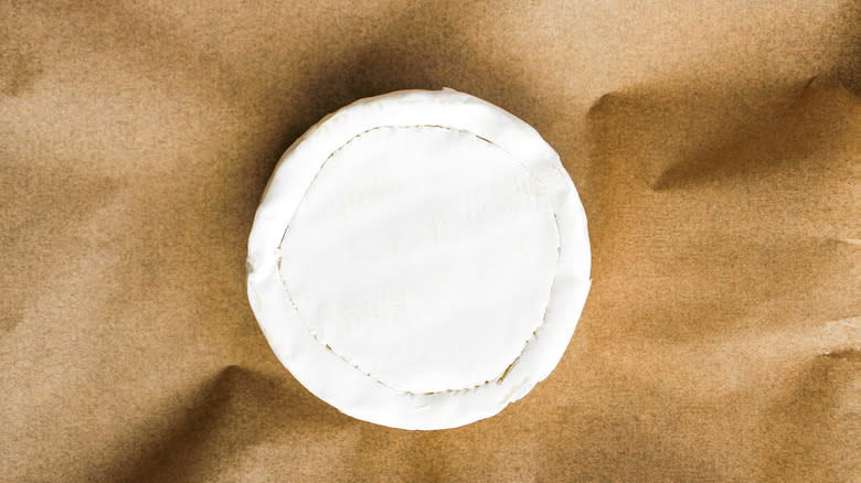 brie cheese wheel on parchment paper