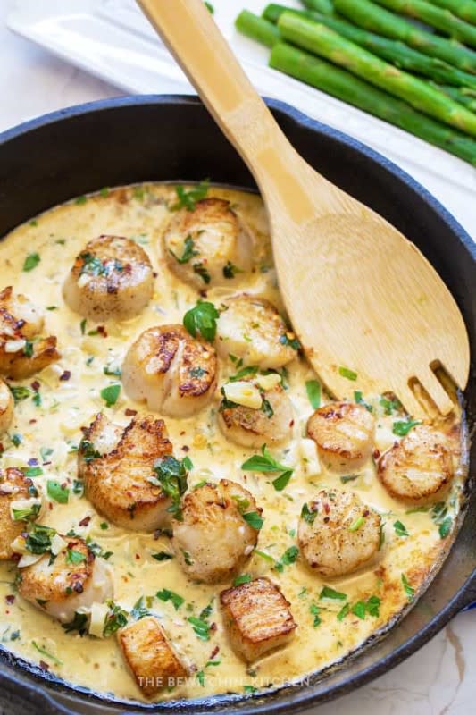 <p>The Bewitchin' Kitchen</p><p>This super quick recipe for pan-seared scallops with a creamy garlic white wine sauce is so easy and you probably have most of what you need in your house right now!</p><p><strong>Get the recipe: <a href="https://www.thebewitchinkitchen.com/seared-scallops-creamy-garlic-sauce/" rel="nofollow noopener" target="_blank" data-ylk="slk:Seared Scallops with Creamy Garlic Sauce;elm:context_link;itc:0;sec:content-canvas" class="link rapid-noclick-resp">Seared Scallops with Creamy Garlic Sauce</a></strong></p>