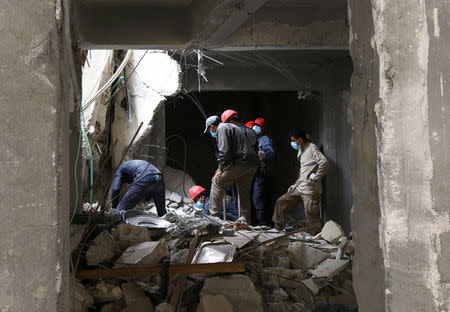 Rescue workers search for bodies still trapped under mounds of debris in Raqqa, Syria April 9, 2018. Picture taken April 9, 2018. REUTERS/Aboud Hamam