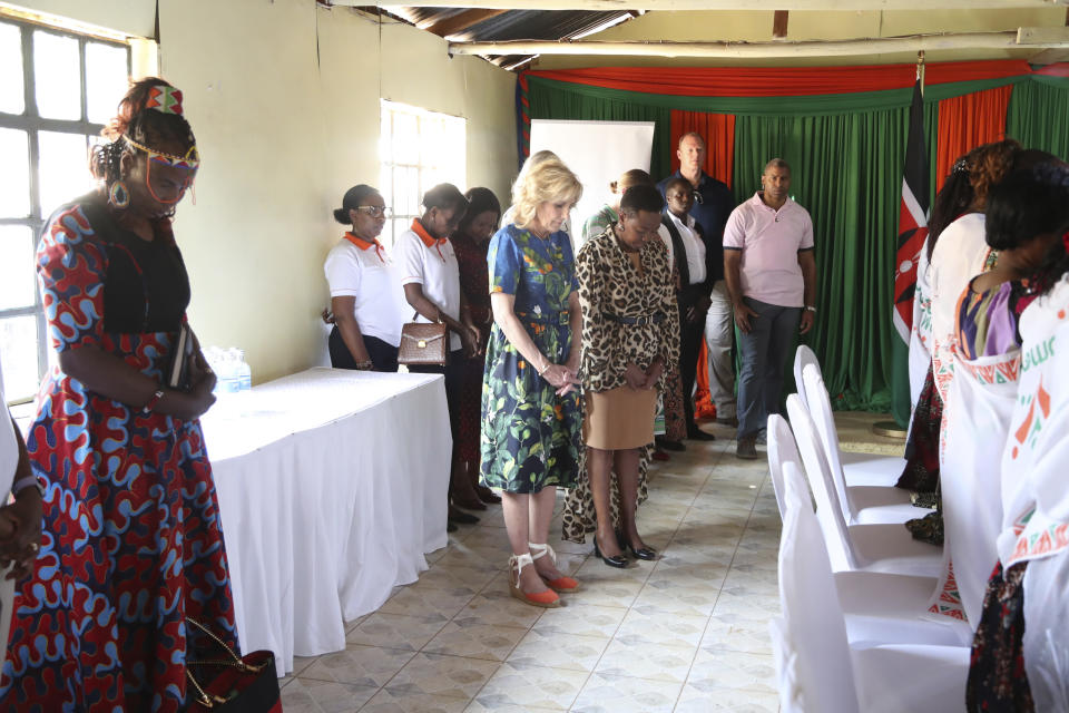 U.S. first lady Jill Biden, centre, prays, during her visit to the Kibera slum in Nairobi, Kenya, Saturday, Feb. 25, 2023. Biden is in Kenya on the second and final stop of her trip. (AP Photo/Brian Inganga)