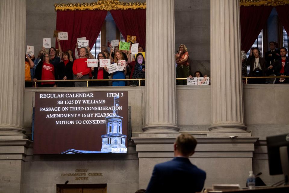 Rep. Ryan Williams, R-Cookeville, presents a bill that would allow armed teachers before the Tennessee House as a crowd of protesters looks on from the gallery on April 23 at the Tennessee Capitol in Nashville.