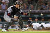 Detroit Tigers' Victor Reyes slides safely into home plate as Chicago White Sox catcher Yasmani Grandal (24) receives the throw in the third inning of a baseball game in Detroit, Monday, Sept. 20, 2021. (AP Photo/Paul Sancya)