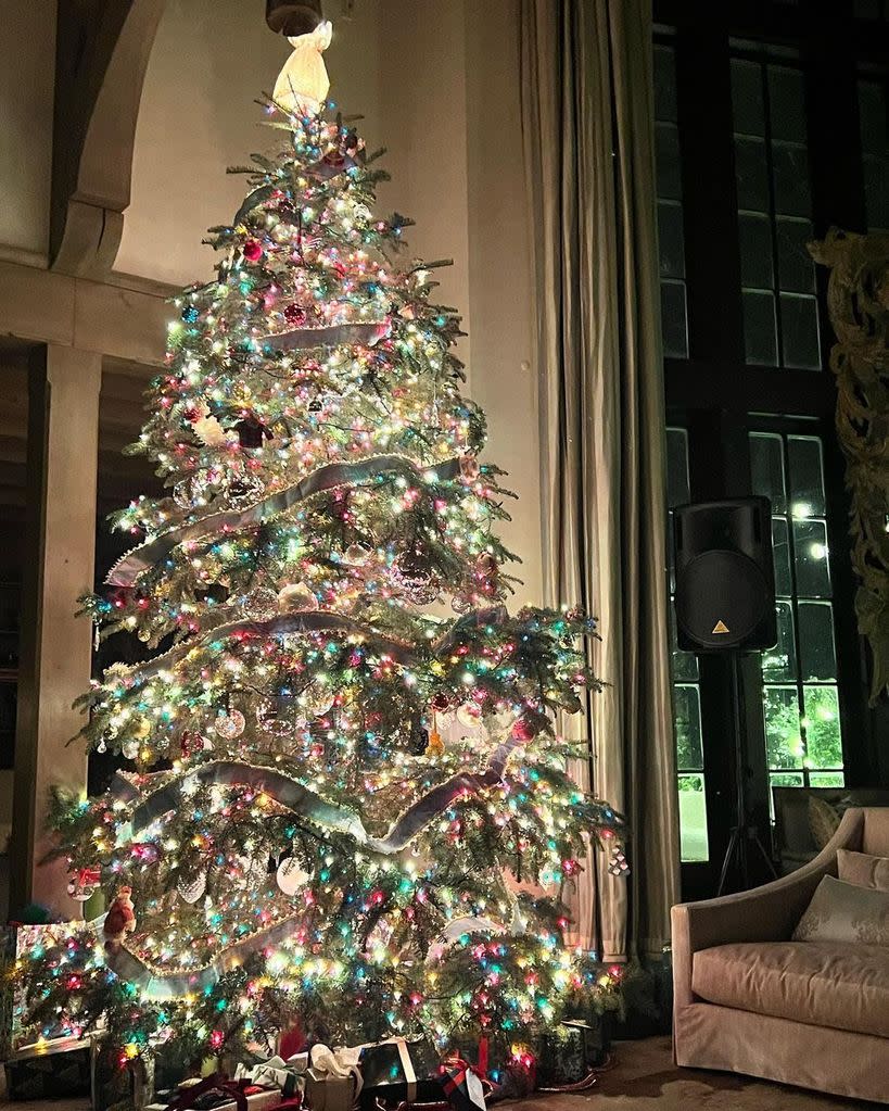 Tim and Faith's Christmas tree with colourful lights next to a window