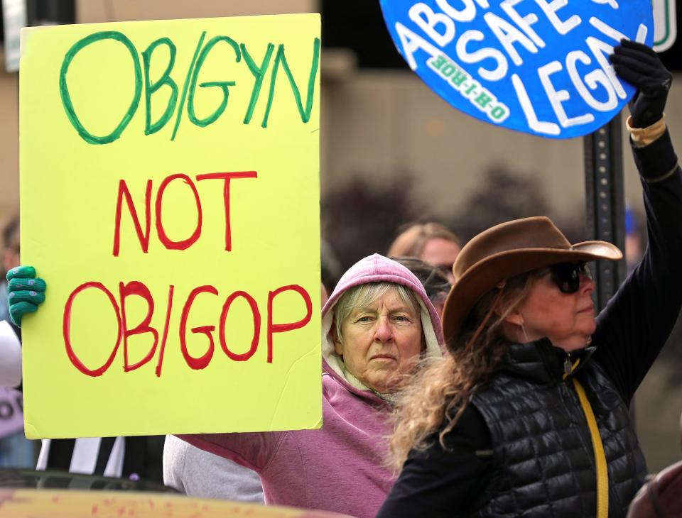 Linda Bunyan of Akron, center, participates in the Bans Off Akron rally for reproductive rights Sunday outside Akron City Hall,.