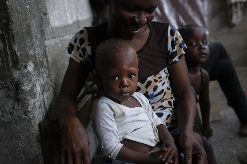 Children look into the camera inside a school turned shelter, created about a month ago for families displaced by gang violence in Petion Ville in Port-au-Prince, Haiti, Tuesday, July 13, 2021. President Jovenel Moise was assassinated on July 7. (AP Photo/Matias Delacroix)