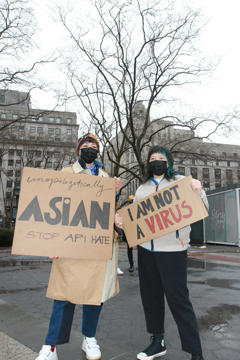   Demonstrators at Saturday's rally holding signs. / Credit: Anokha Venugopal via Asian American Federation