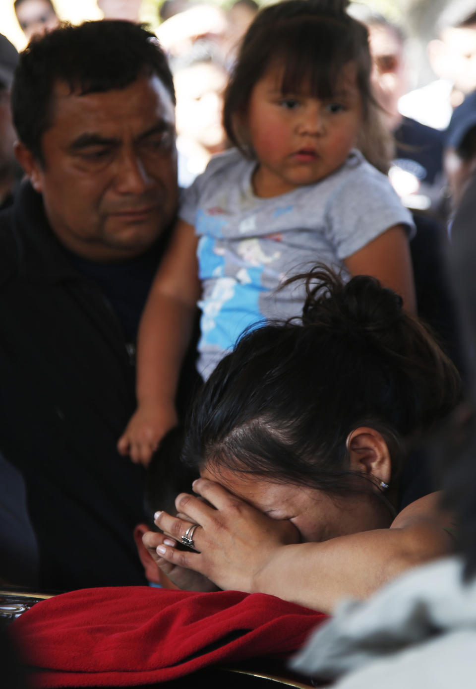 A woman cries during the funeral of a person who died when a gas pipeline exploded in the village of Tlahuelilpan, Mexico, Sunday, Jan. 20, 2019. A massive fireball that engulfed locals scooping up fuel spilling from a pipeline ruptured by thieves in central Mexico killed dozens of people and badly burned dozens more on Jan. 18. (AP Photo/Claudio Cruz)