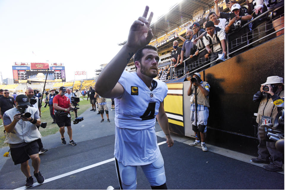 Las Vegas Raiders quarterback Derek Carr (4) waves to fans as he heads to the locker room following an NFL football game against the Pittsburgh Steelers in Pittsburgh, Sunday, Sept. 19, 2021. (AP Photo/Don Wright)