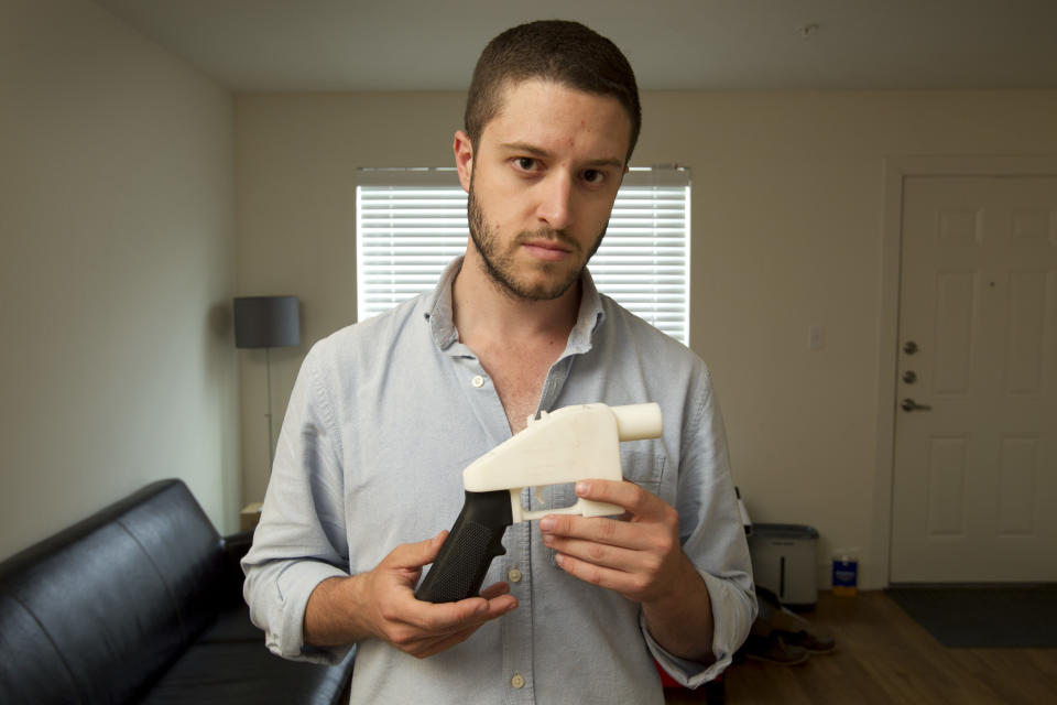 Cody Wilson, the founder of Defense Distributed, shows a plastic handgun made on a 3D-printer at his home in Austin, Texas. Eight states filed suit Monday, July 30, 2018, against the Trump administration over its decision to allow a Texas company to publish downloadable blueprints for a 3D-printed gun. (Jay Janner/Austin American-Statesman via AP, File)