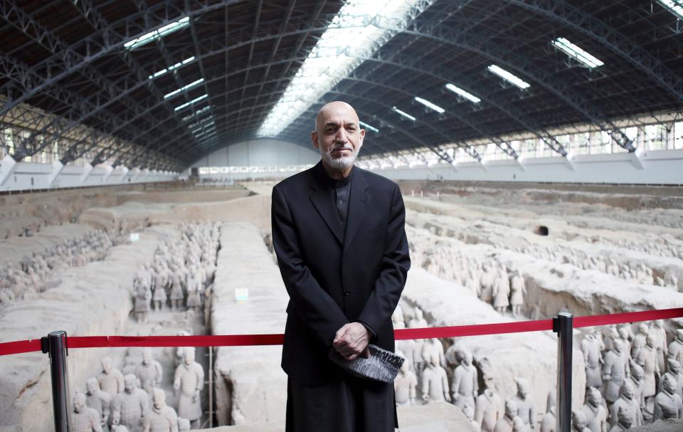 Afghanistan's President Karzai poses for photographs as he visits the Museum of Qin Terracotta Warriors and Horses during his trip in Xi'an