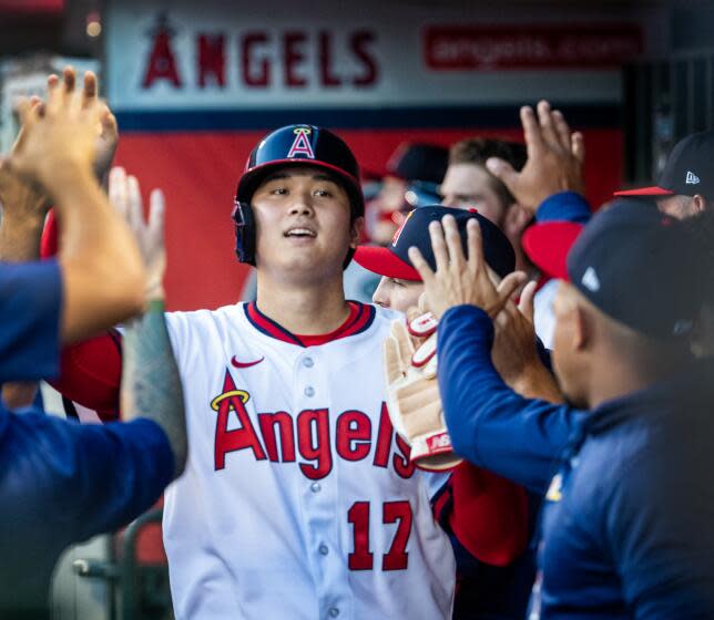 Anaheim, CA - July 21: Angels starting pitcher and two-way player Shohei Ohtani is congratulated.