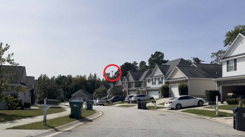 In this photo simulation prepared by a real estate developer, a red circle shows where a proposed T-Mobile cell tower could peek above the tree line in Grovetown's High Meadows neighborhood if the tower were constructed as requested.
